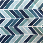 Detail of fabric in a geometric herringbone print in blue, turquoise and navy on a white field.