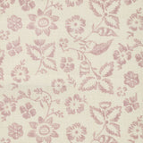 Detail of fabric in a floral print in shades of pink on a tan field.