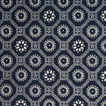 Detail of a cotton fabric in a floral gridded honeycomb pattern in white on an indigo field.