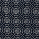 printed cotton fabric in a floral gridded honeycomb pattern in white on an indigo field.