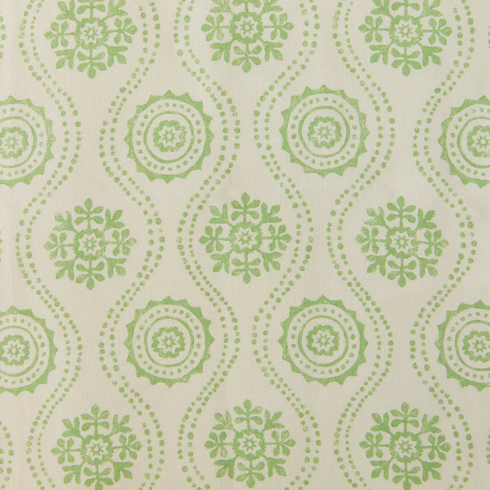 Detail of fabric in a playful floral stripe in green on a cream field.