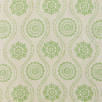 Detail of fabric in a playful floral stripe in green on a cream field.