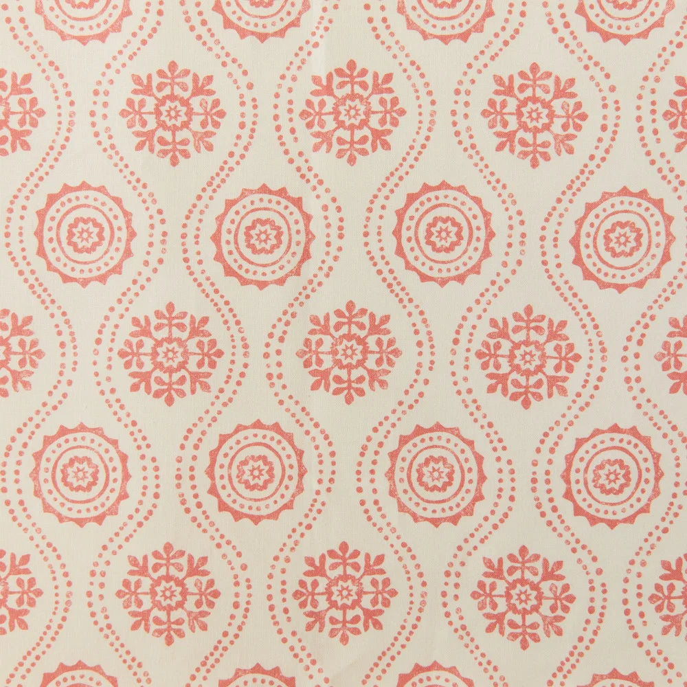 Detail of fabric in a playful floral stripe in orange on a cream field.