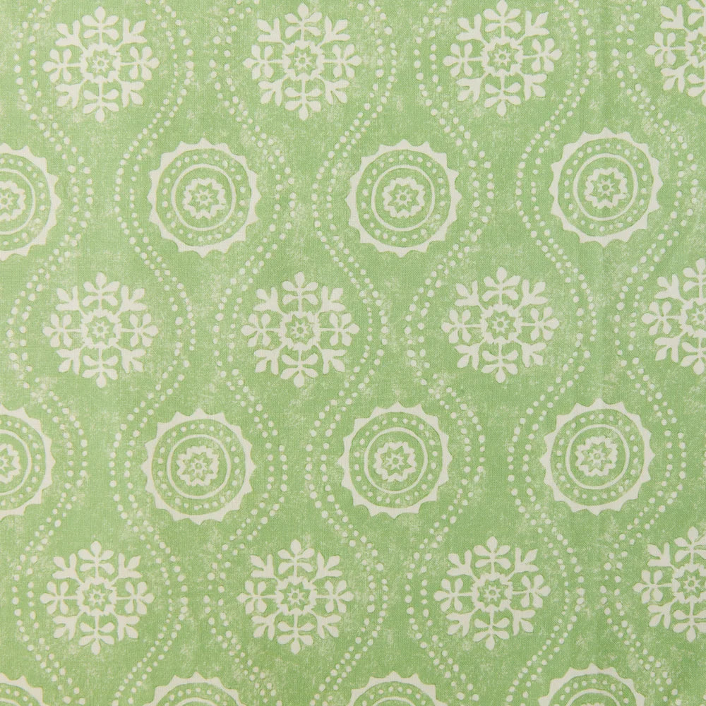 Detail of fabric in a playful floral stripe in cream on a green field.