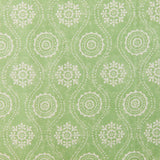 Detail of fabric in a playful floral stripe in cream on a green field.