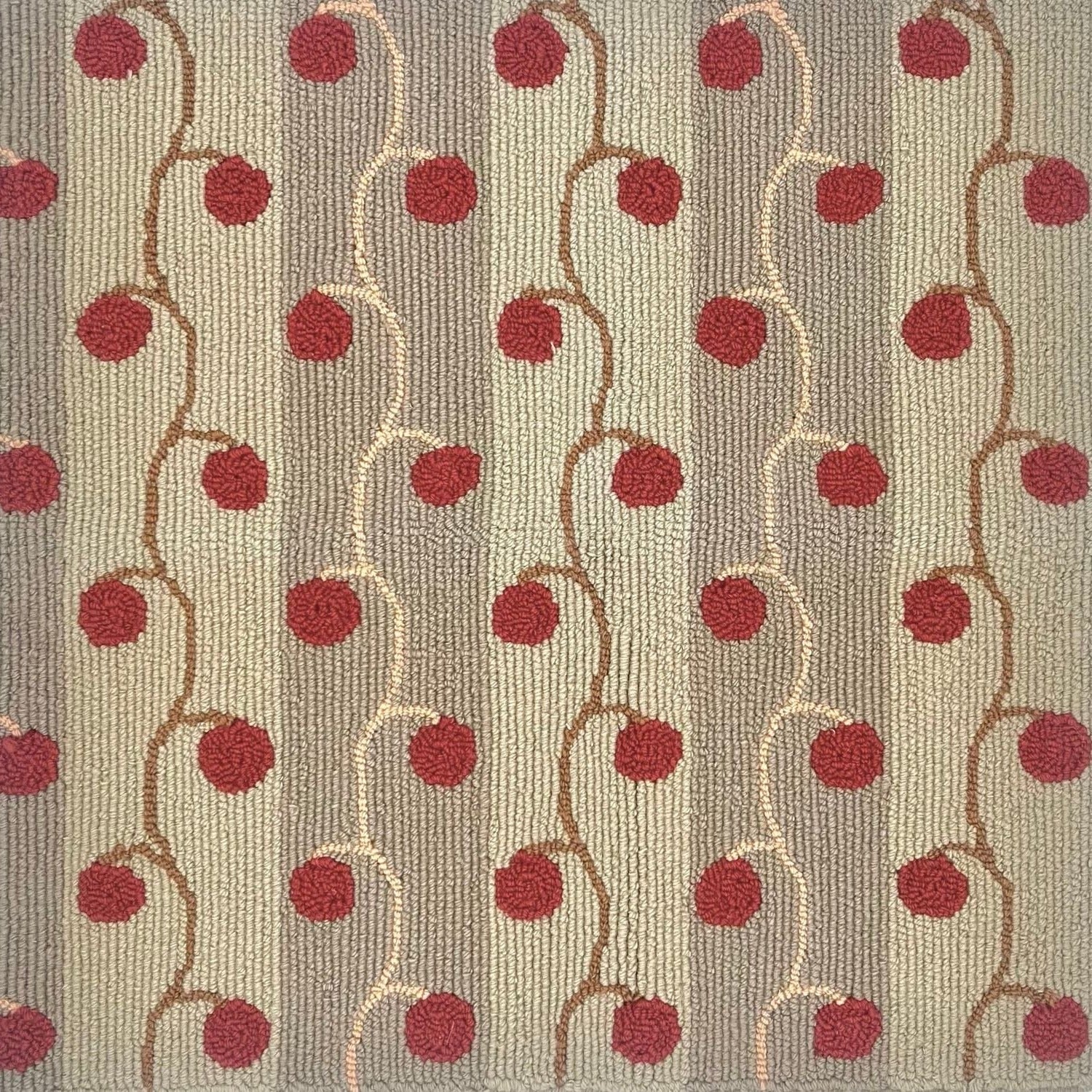Detail of handtufted rugh with red cherry vines against neutral stripes