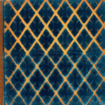A hand tufted rug with raised blue diamond patterns on a flat tan lattice ground