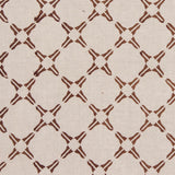 Detail of fabric in a geometric lattice print in rust on a tan field.