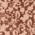 Printed linen in a blush pink floral silhouette motif on rust brown field. 