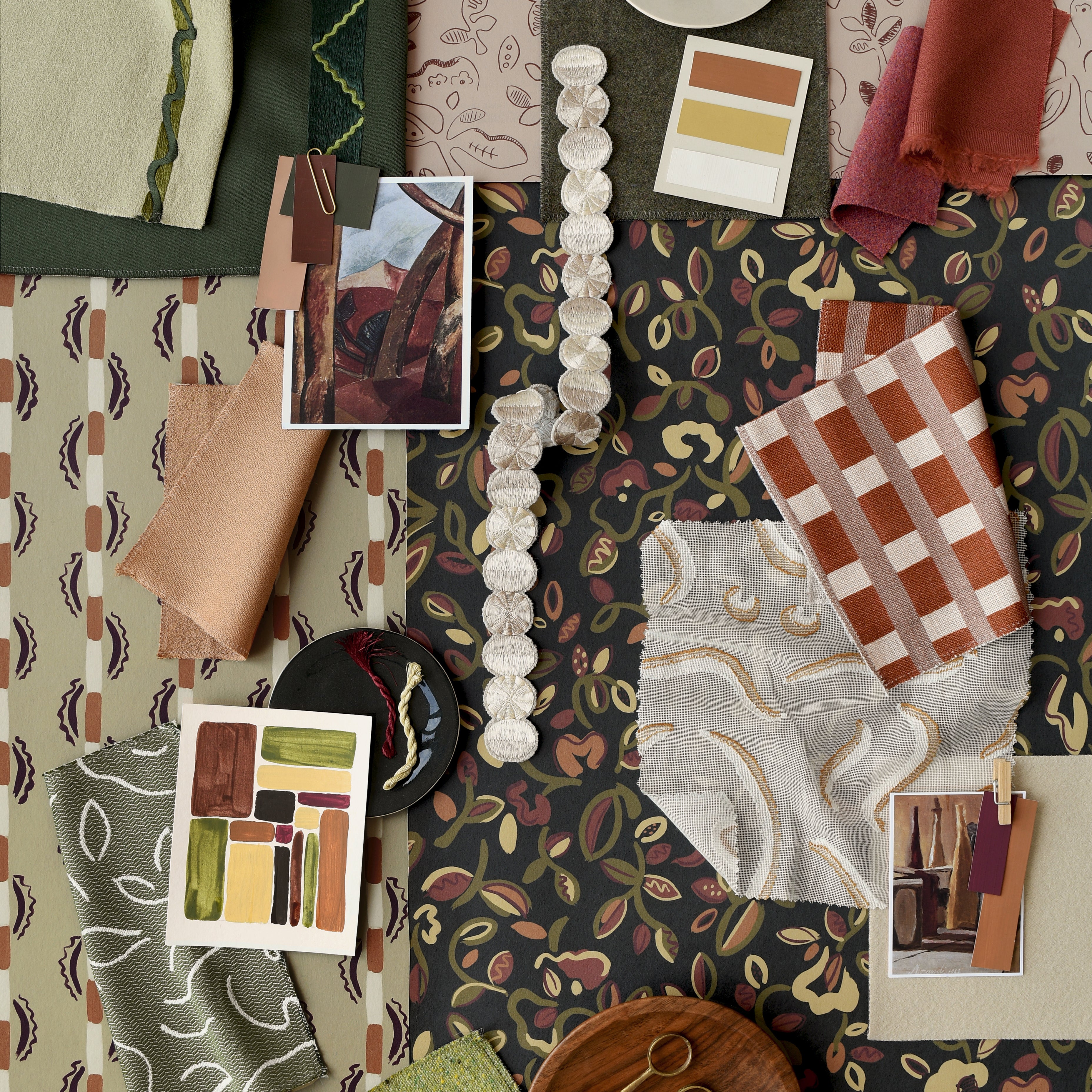 Collage of fabric swatches and color samples on a patterned background in shades of green, brown and orange. 