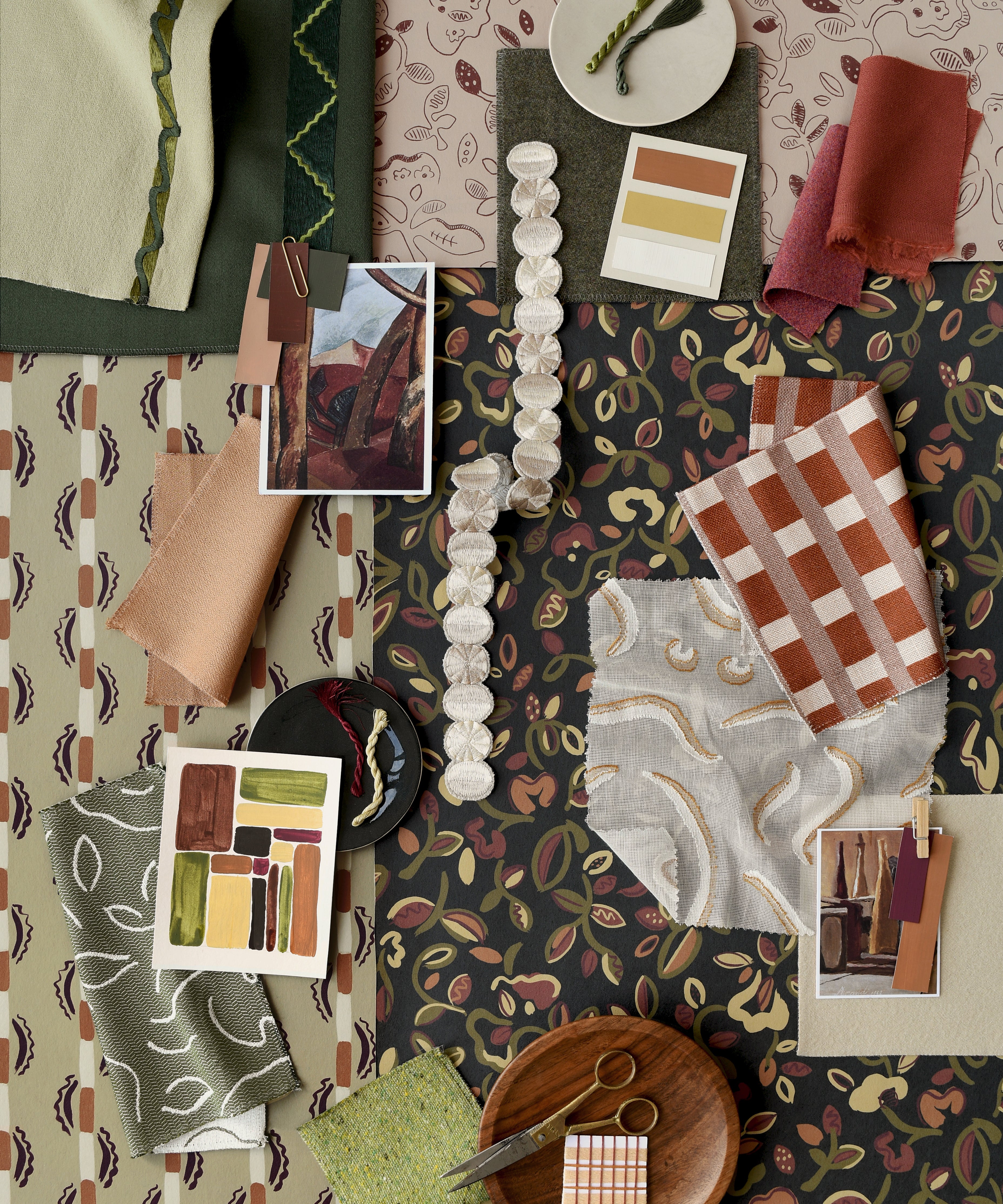 Collage of fabric swatches and color samples on a patterned background in shades of green, brown and orange. 