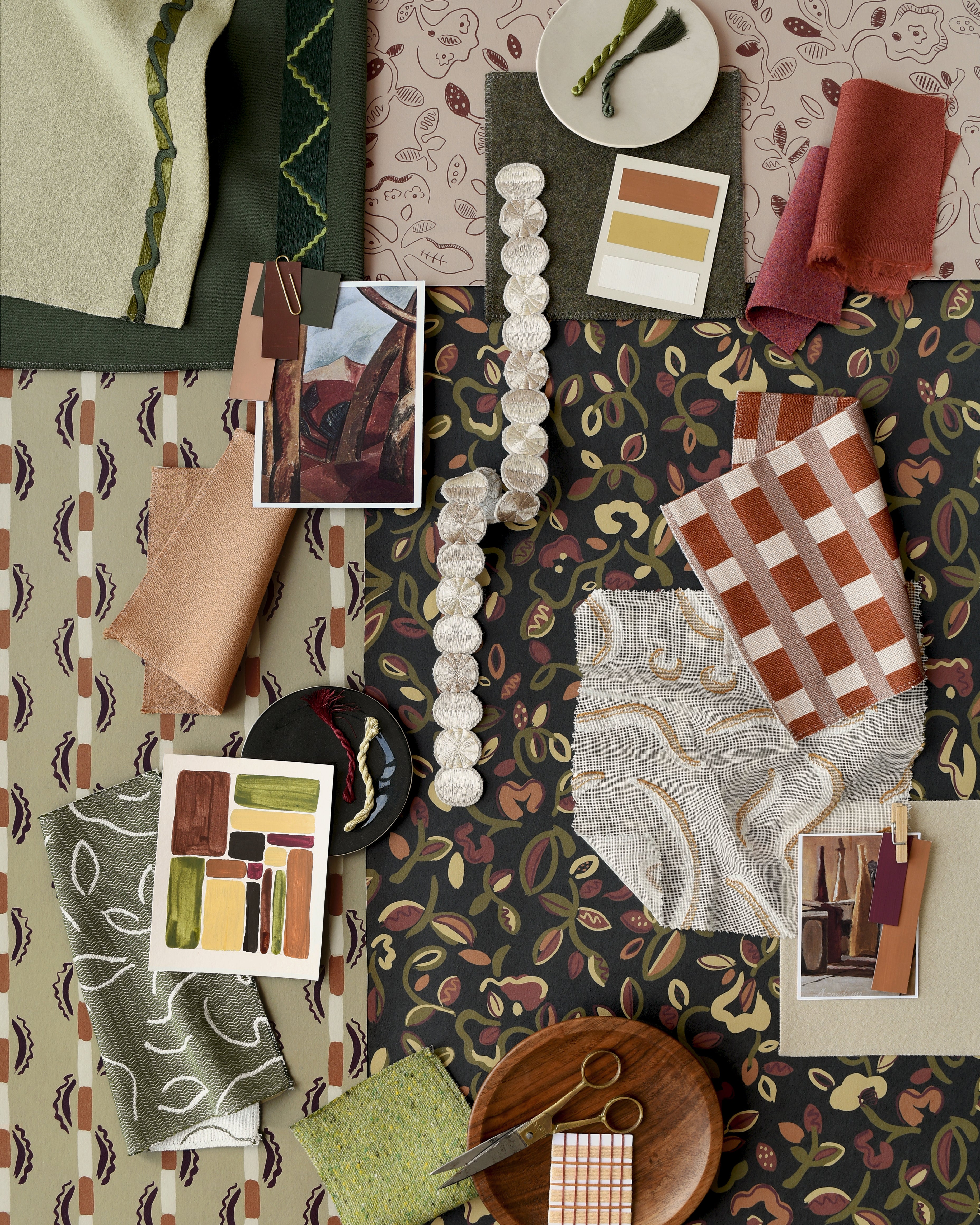 Collage of fabric swatches and color samples on a patterned background in shades of green, brown and orange. 