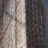 Overhead shot of a woven leather rug in a stripe dgrid texture in shades of brown and cream.