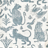 Close-up of fabric in a lion and plant print in blue-gray on a mottled white field.