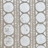 Detail of wallpaper in a circle and stripe print in white on a oatmeal field.