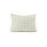 Back view of a rectangular throw pillow with a repeating cream and greige diamond field.