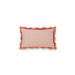 Rectangular throw pillow with a wave-like scallop trim and an embroidered scallop pattern in coral and cream.