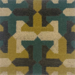 Close-up of a geometric patterned rug with green, brown, and beige colors.