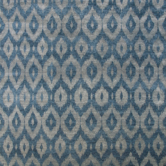 Full size rendering of a green and turquoise silk rug woven in an ikat geometric pattern.