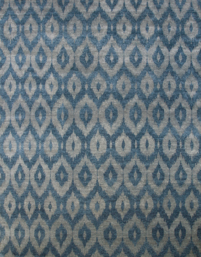 Full size rendering of a green and turquoise silk rug woven in an ikat geometric pattern.