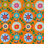 Detail of wallpaper in a playful floral pattern in a rainbow of colors on an orange field.