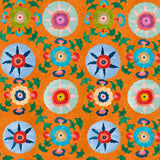 Detail of wallpaper in a playful floral pattern in a rainbow of colors on an orange field.