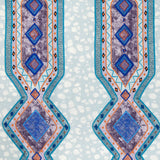 Detail of fabric in a geometric stripe pattern in shades of blue, orange and navy.