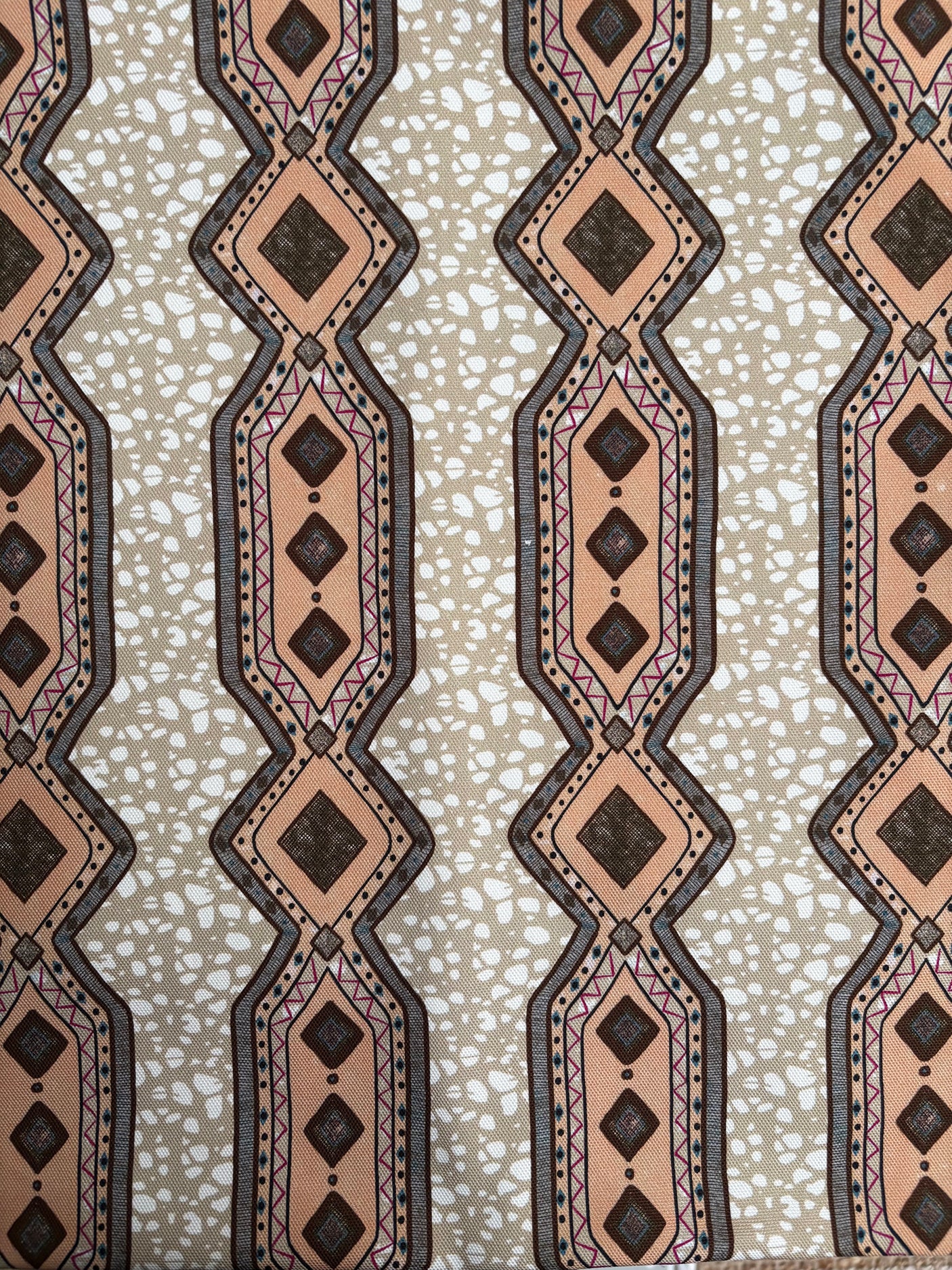 Patterned fabric with geometric design on a beige background