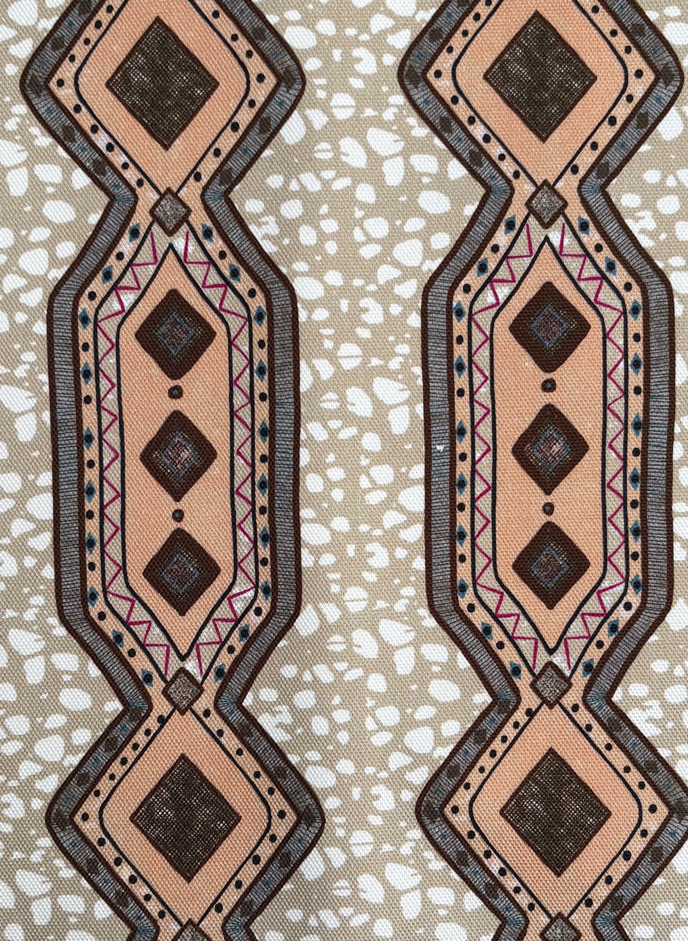 Decorative fabric strip with geometric pattern on a textured beige background