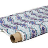 Partially unrolled fabric in a geometric stripe pattern in shades of blue, orange and navy.