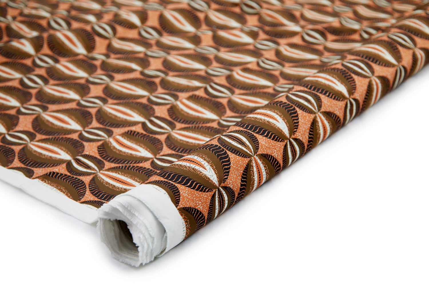 Partially unrolled fabric in an interlocking circular stripe print in shades of orange, brown and black on an orange field.