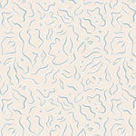 Detail of wallpaper in a painterly floral print in blue and white on a tan field.