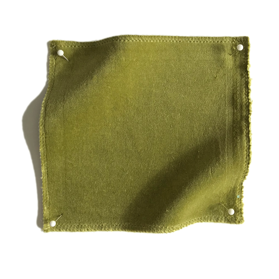 Square fabric swatch of velvet in an olive colorway.