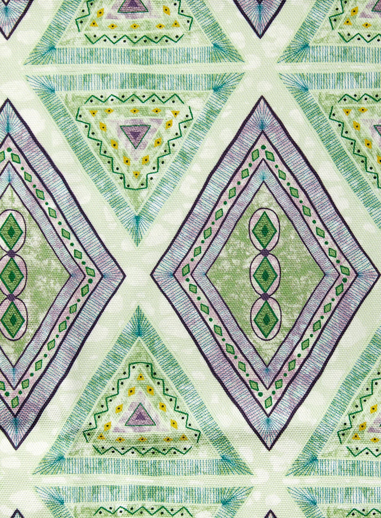Detail of fabric in an intricate diamond grid pattern in shades of green and purple.