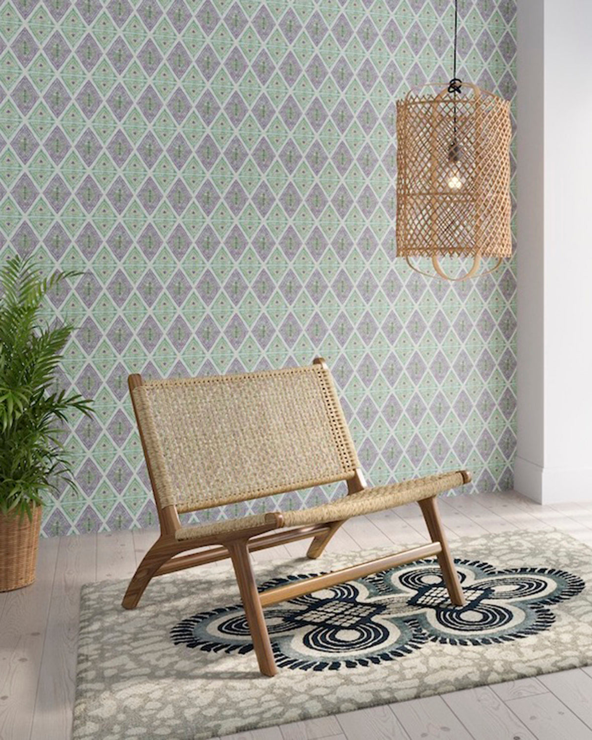 Styled living room tableau with a wall papered in an intricate diamond grid pattern in green and purple.