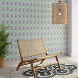 Styled living room tableau with a wall papered in an intricate diamond grid pattern in green and purple.