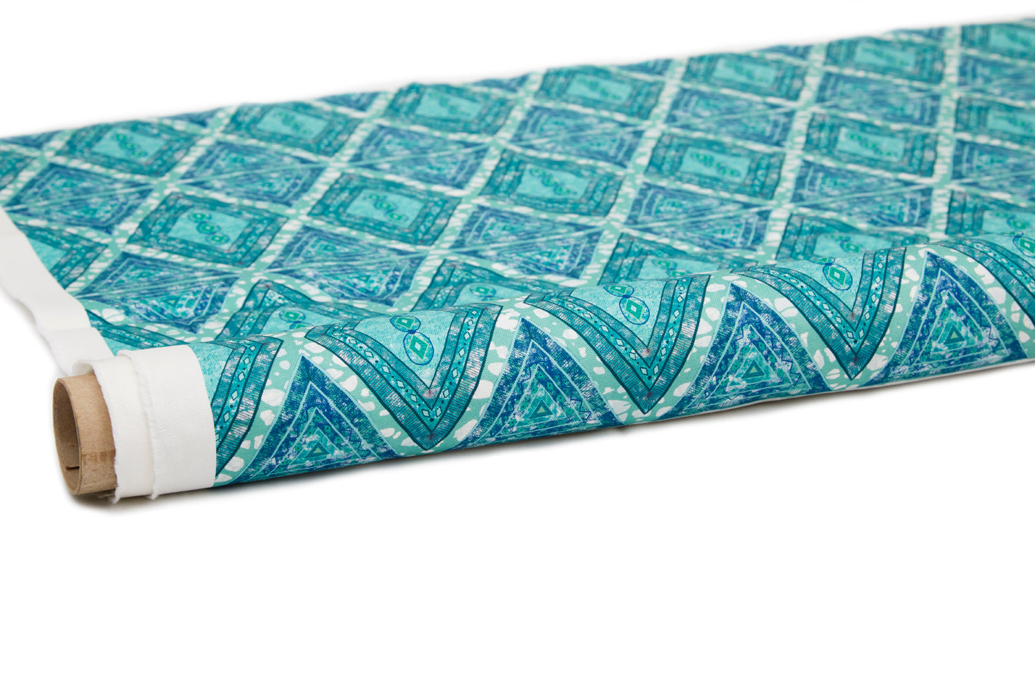 Partially unrolled fabric in an intricate diamond grid pattern in shades of blue and turquoise.