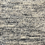 Textural bouclé broadloom carpet in charcoal and cream.