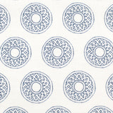 Detail of fabric in a repeating circular geometric print in navy on a white field.