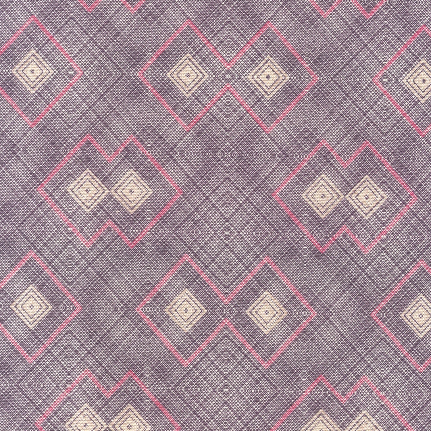 Detail of fabric in a detailed diamond lattice print in shades of pink and tan on a purple field.