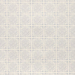 Detail of fabric in a damask lattice print in blue on a cream field.