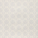 Detail of fabric in a damask lattice print in blue on a cream field.