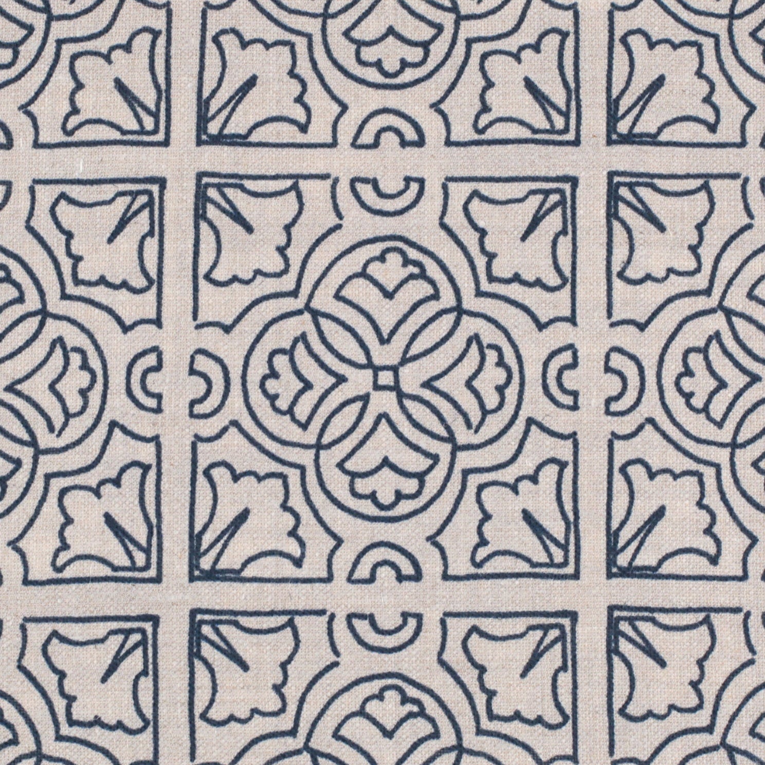 Detail of fabric in a damask lattice print in navy on a cream field.