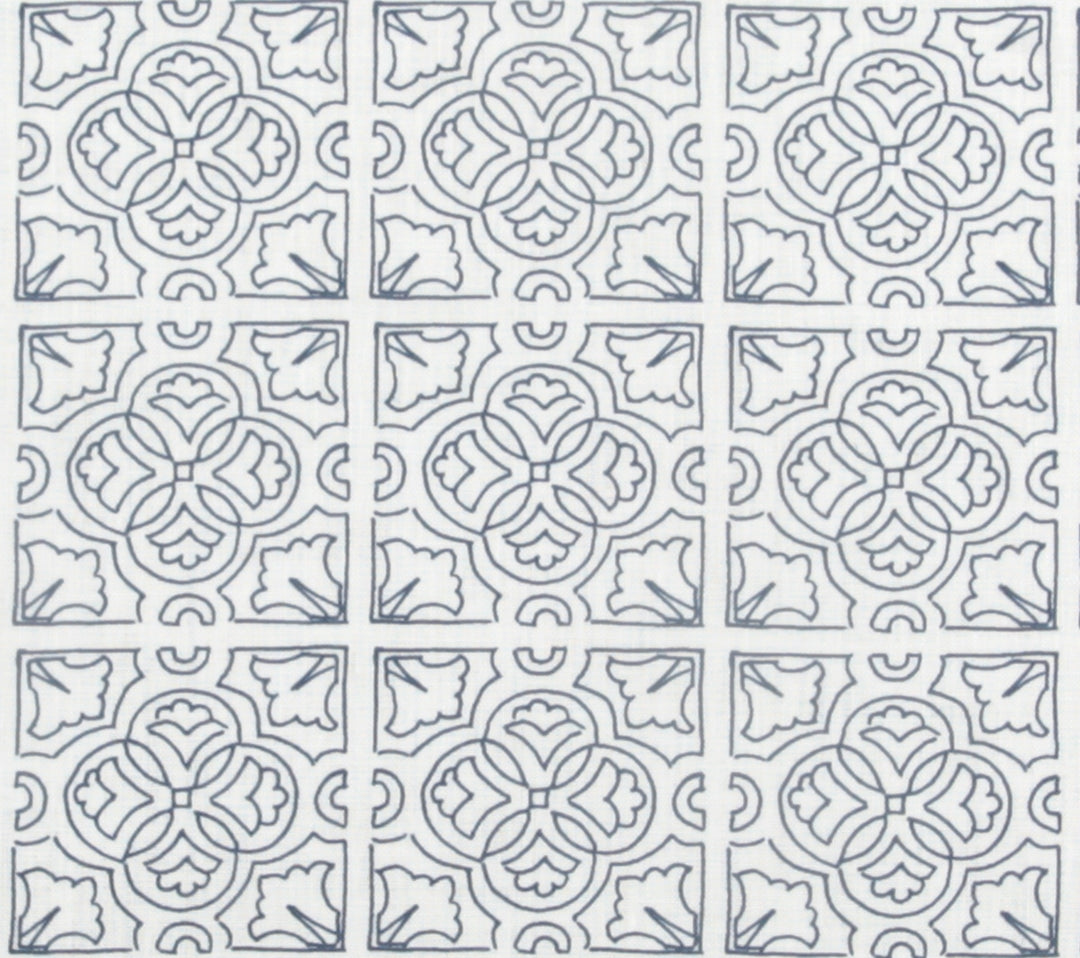 Detail of fabric in a damask lattice print in navy on a white field.