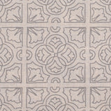 Detail of fabric in a damask lattice print in light gray on a tan field.