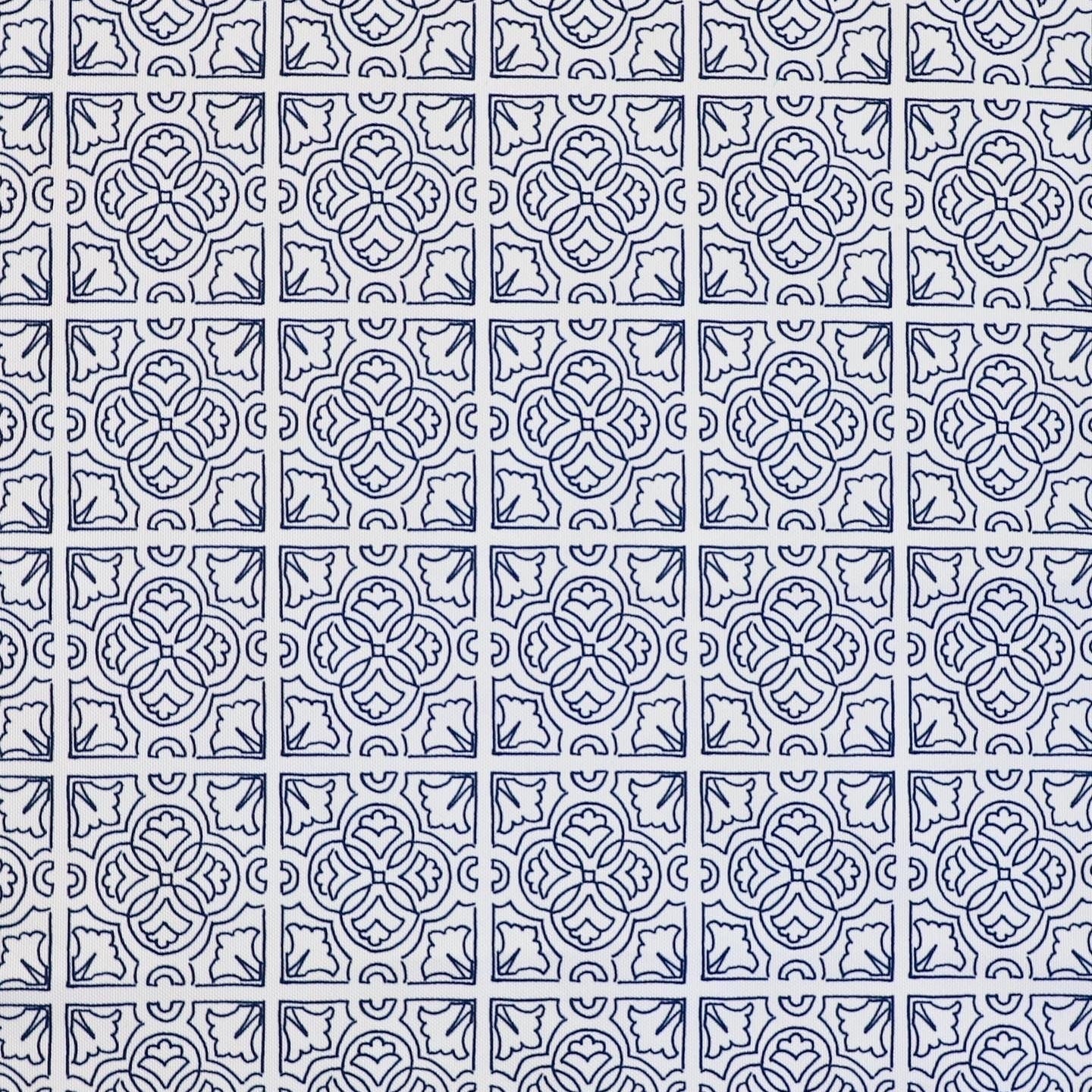 Detail of fabric in a damask lattice print in navy on a white field.