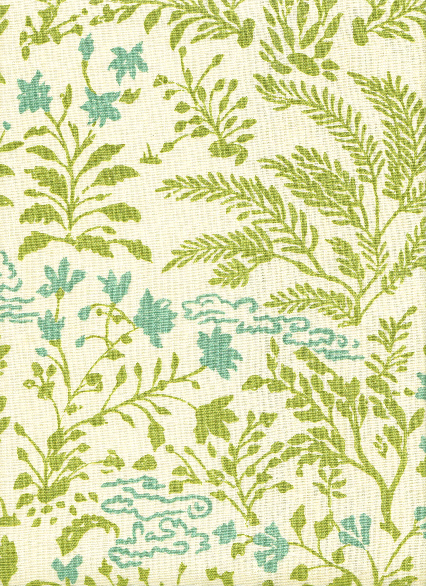 Detail of fabric in a botanical and cloud print in green and blue on a cream field.