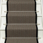 Striped flatweave runner in black and ivory on white staircase