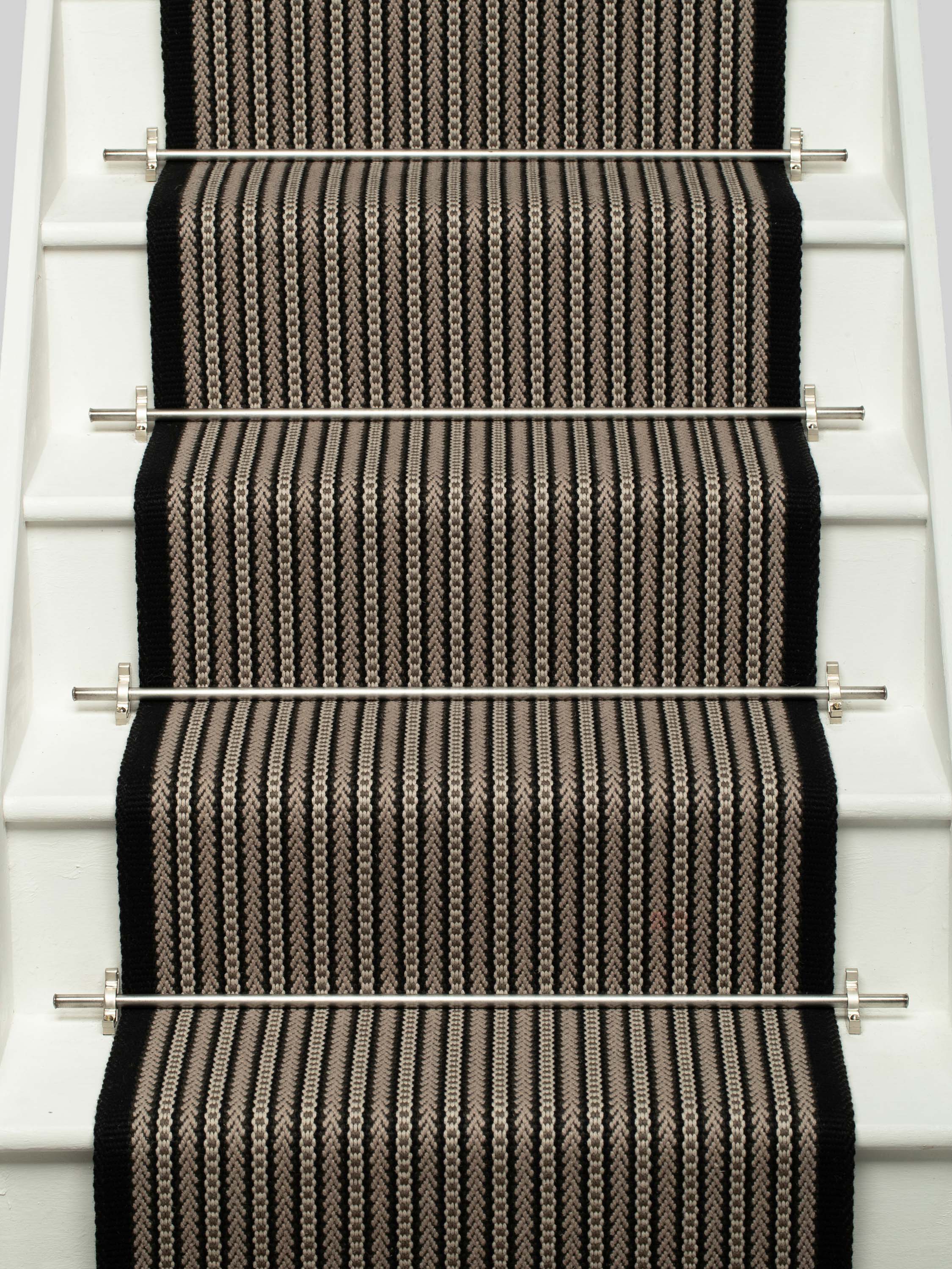 Striped flatweave runner in black and ivory on white staircase