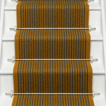 Striped flatweave runner in mustard black and ivory on white staircase